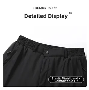 Detail of winter thermal trousers featuring elastic waist, snap button, and zip pockets