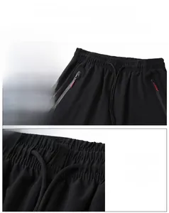 Detail of elastic waist and drawstring design on men's quick-dry black ice silk trousers