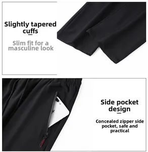 Detail of men's black ice silk pants showing zip pockets and tapered cuffs for a slim fit