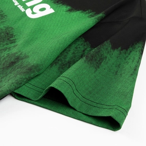 Macro detail of breathable mesh fabric and printed graphic on black-green sports jersey
