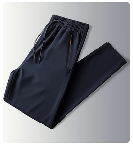 Detail of dark blue quick-dry pants featuring elastic waist with drawstring and zip pocket