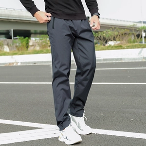 Detail view of men's dark grey thermal fleece trousers with waterproof zipper pockets