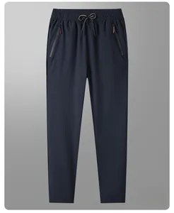 Detail view of dark blue ice silk straight pants with elastic drawstring waist and side pockets