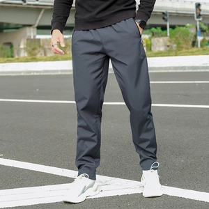 Detail of dark grey winter fleece sweatpants featuring secure zipper pockets and elastic waist