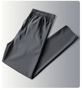 Detail of dark grey ice silk pants showing elastic waist with drawstring and zipper pocket