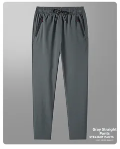 Detail of grey ice silk trousers featuring elastic drawstring waist and zip pockets
