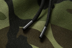 Macro detail of camouflage cargo pants showing knit fabric texture and durable drawstrings