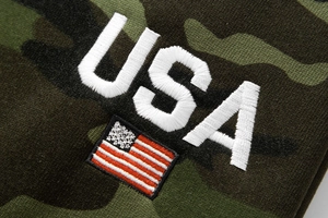 Close-up of USA embroidery and flag patch on camo fleece cargo sweatpants for men