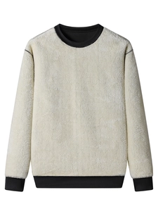 Detail view of lambswool sweatshirt featuring black ribbed crew neck and cuff stitching