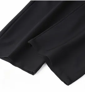 Close-up of straight-leg hem on black ice silk pants showing clean single-stitch sewing