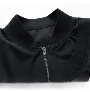 Close-up of the ribbed knit neckline and metal zipper on this black bomber jacket