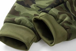 Detailed close-up of tactical camo joggers featuring thick green elastic ribbed cuffs