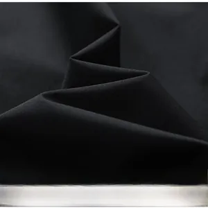 Close-up of premium black twill fabric showing fine texture and weave for baseball jacket