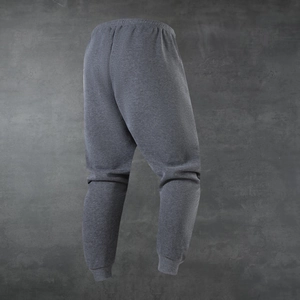 Close-up of elastic waistband and grey knit fabric texture on men's jogger pants