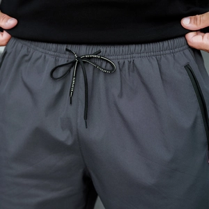 Detail of men's dark grey thermal joggers with elastic waistband and KESPORTS drawstring