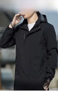 Detail of adjustable Velcro cuff on waterproof black hooded jacket for men