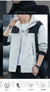 Detail of waterproof outdoor jacket showing color-block design and protective hood