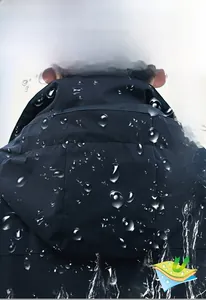 Close-up of waterproof black hooded jacket fabric showing lotus leaf water repellent effect