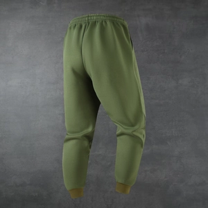 Detail view of army green joggers showing elastic waistband and ribbed ankle cuffs