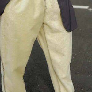 Detail of thick fleece lining in men's winter trousers showing warm texture