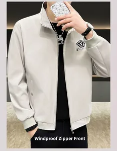 Close-up of light grey windproof jacket featuring zip closure and shield logo embroidery