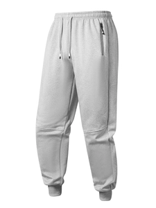 Detail of grey fleece joggers with elastic drawstring waist and textured zip pocket