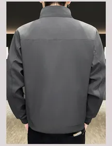 Rear view detail of dark gray jacket showing back seam and elastic ribbed hem