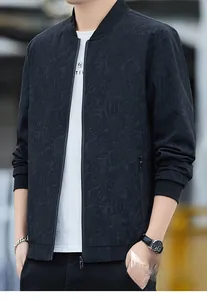 Close-up of men's black bomber jacket with subtle palm leaf texture and stand collar