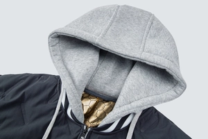 Detail of hooded jacket with golden honeycomb lining and grey knit drawstring hood