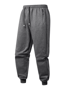 Detail view of heather gray sweatpants featuring zip pocket and elastic drawstring waistband