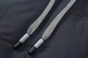 Detail shot of grey woven drawstrings and breathable honeycomb texture on a blue hoodie