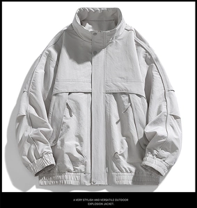 Detail view of light grey outdoor jacket featuring wrinkle-resistant fabric and utility pockets