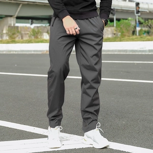 Detail of dark grey winter fleece pants with slim fit and side pockets for men