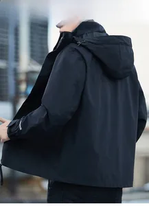 Rear view of black waterproof jacket showing outdoor sleeve detail and adjustable hood