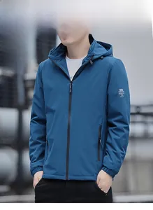 Detail of dark blue windproof jacket showing hooded design and zip pocket for men