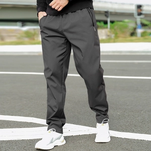 Detail of dark grey winter fleece pants featuring a hidden zipper pocket for men