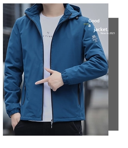 Detail view of the elastic cuffs and zippered pockets on a men's blue windbreaker jacket