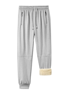 Detail showing plush sherpa lining and grey fleece jogger pants with zipper pockets