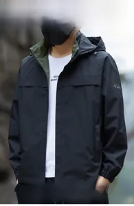 Detail of waterproof outdoor jacket with hood and contrasting dark green collar lining