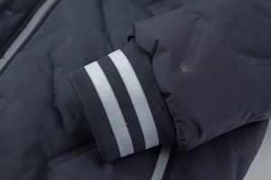 Close-up of winter jacket cuff with ribbed knit details and embossed dot texture fabric