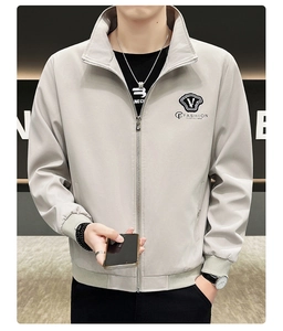 Close-up of light gray men's zip jacket showing sleek fabric and rib-knit cuffs