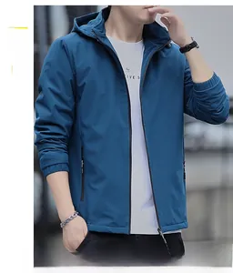 Detail of a men's navy windproof hooded jacket featuring a vertical chest zipper pocket