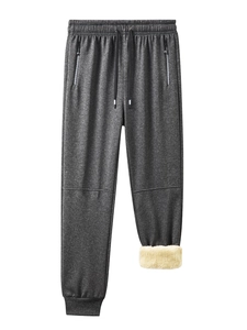 Detail of dark grey jogger with zipper pockets and warm sherpa fleece lining