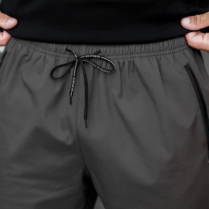 Detail of winter warm joggers with elastic drawstring waist and hidden zipper pockets