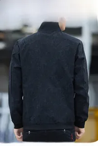 Detailed back view of men's black bomber jacket with subtle leaf pattern print