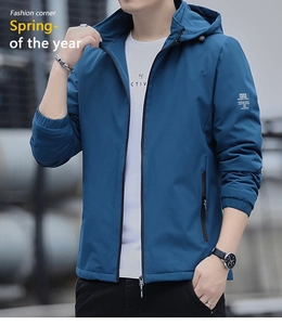 Detail of blue windproof hooded jacket with sleeve lettering and elastic cuffs
