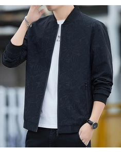 Detail of men's black bomber jacket with subtle leaf pattern and ribbed cuffs texture