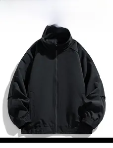 Detail view of black windproof jacket featuring stand collar and full zipper closure system