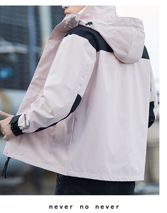 Detail of adjustable black velcro cuffs on a pink and black waterproof outdoor jacket