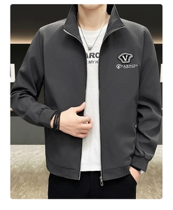 Detail of dark grey casual jacket showing zipper, collar, and chest embroidery patch